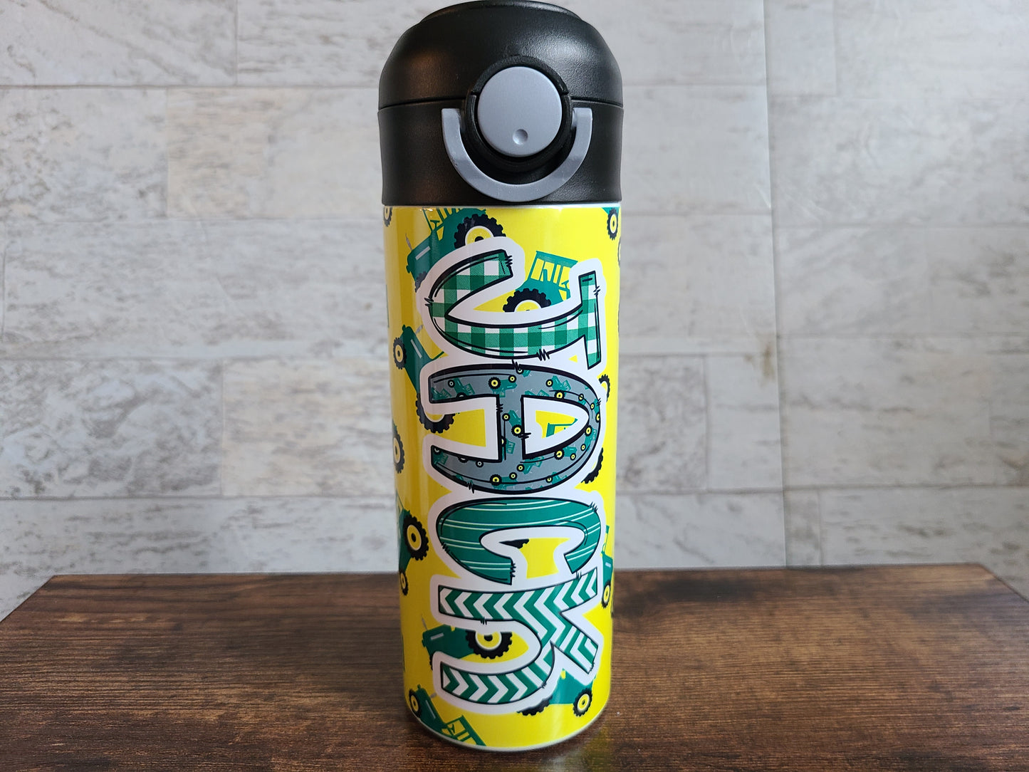 12 oz water bottle with flip top and built in straw. Tractor themed water bottle for kids. Back to school water bottle for kids. Yellow water bottle with green tractors.